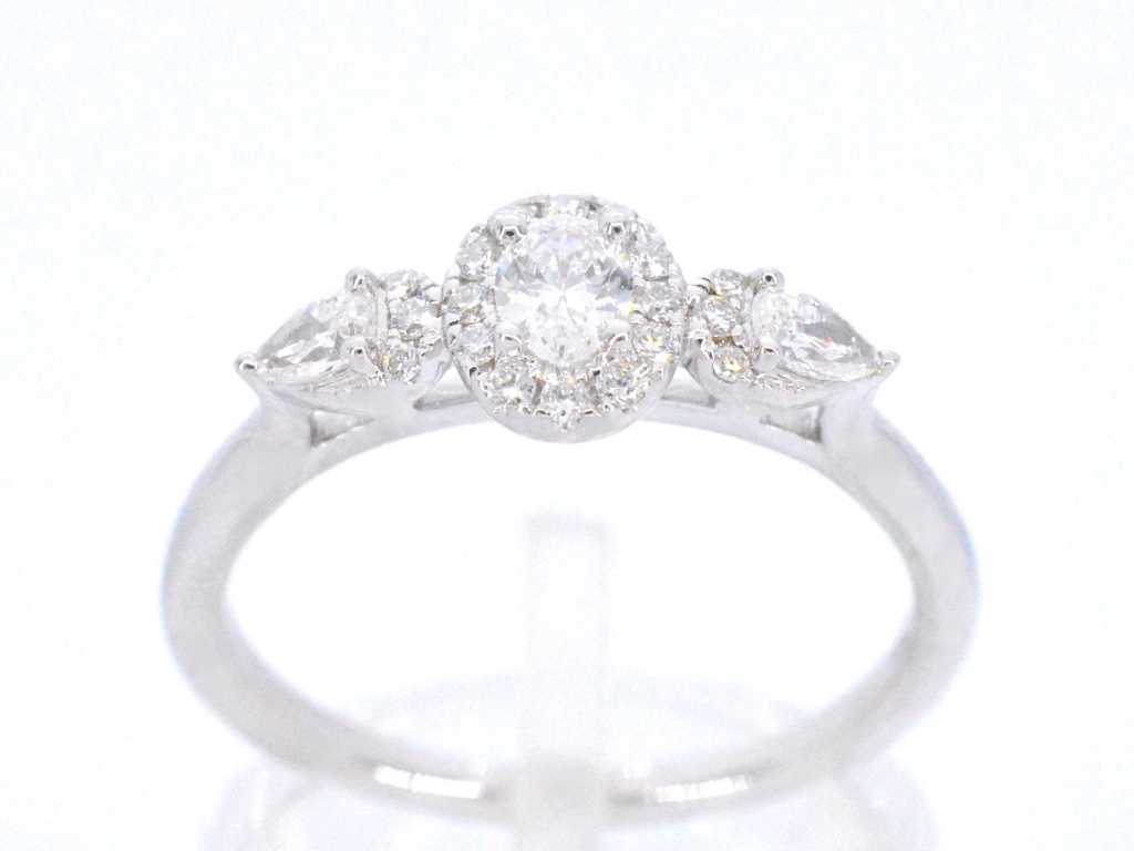 White gold ring with diamonds and an oval cut diamond