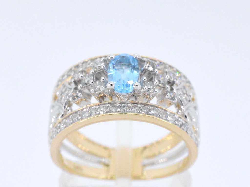 Gouden exclusieve ring vol met diamanten en een edelsteen