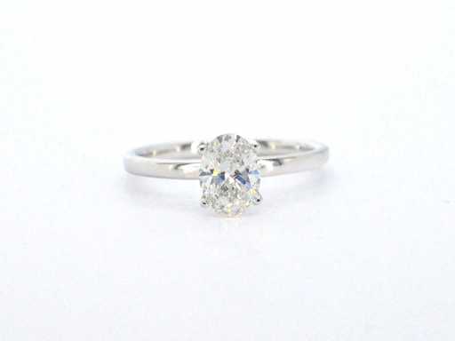 Gold solitaire ring with oval cut diamond