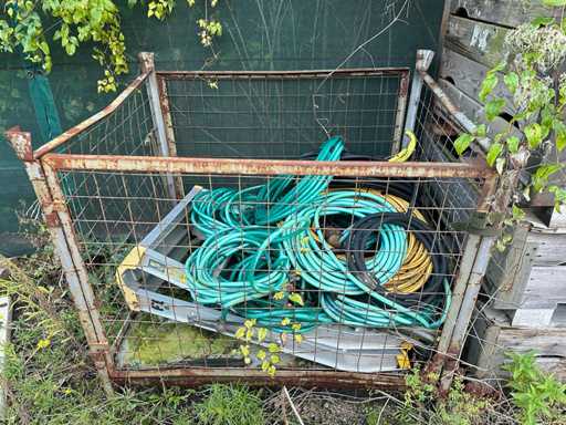 Mesh cage with garden hoses