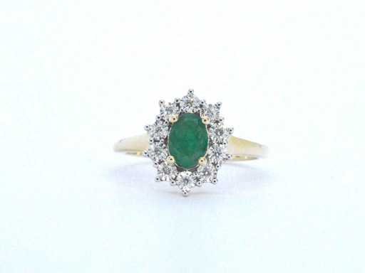 Gold ring with a green oval emerald and natural diamonds