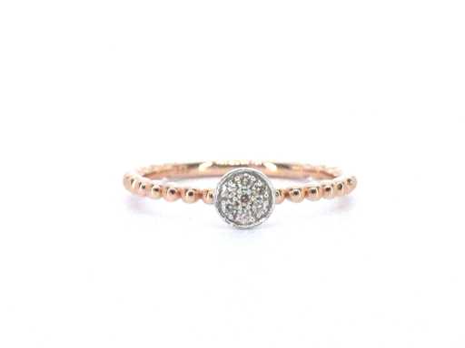 Rose gold ring with a circle full of diamonds in the center