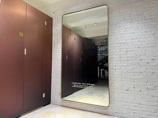 Imposing mirror with elegant brass frame