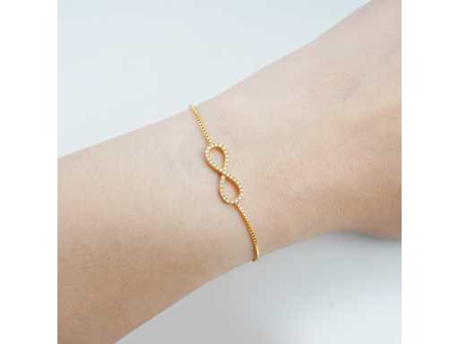 Gold-colored bracelet with infinity symbol set with brilliants