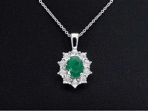 White gold pendant with diamonds and emerald