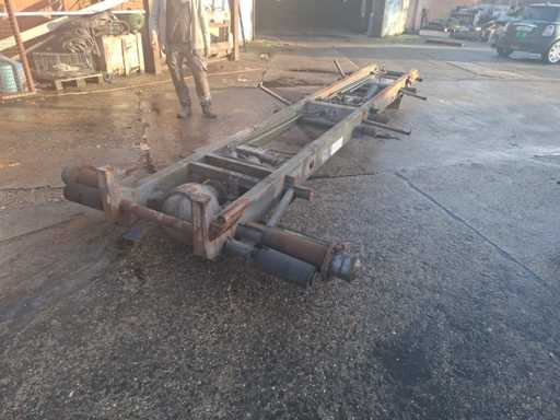 Tandem axle chassis with hydraulic system and driven axle