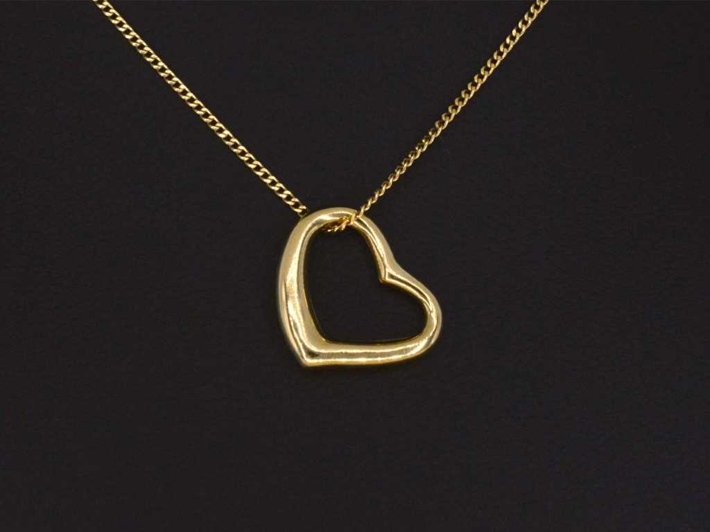 Gold necklace with a pendant in the shape of a heart