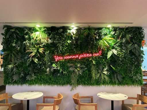 Decorative artificial plant wall with neon