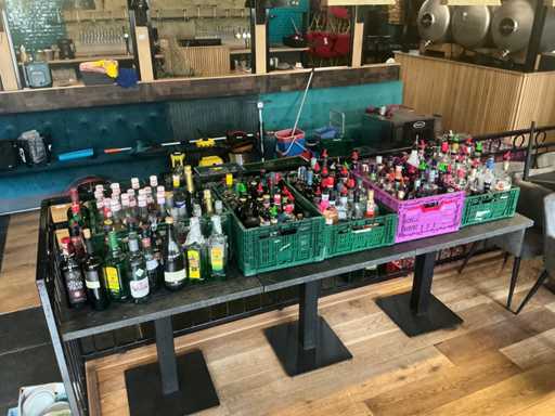 Large batch of opened bottles of spirits