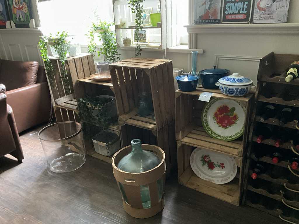 Wooden crates with artificial plants and glassware
