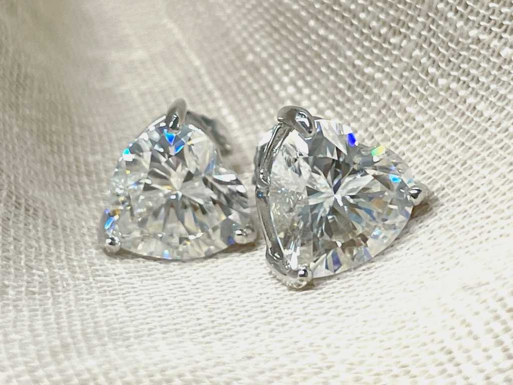 Beautiful solitaire earrings set with two large heart shape brilliants