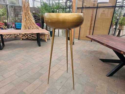 Elegant decorative bowl in brass look on a high tripod frame